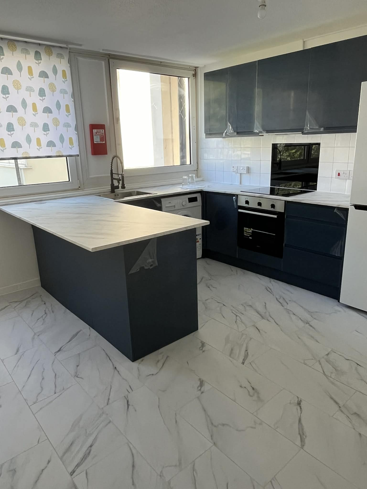 Kitchen Renovation with Underfloor Heating & Marble-Effect Tiling — After